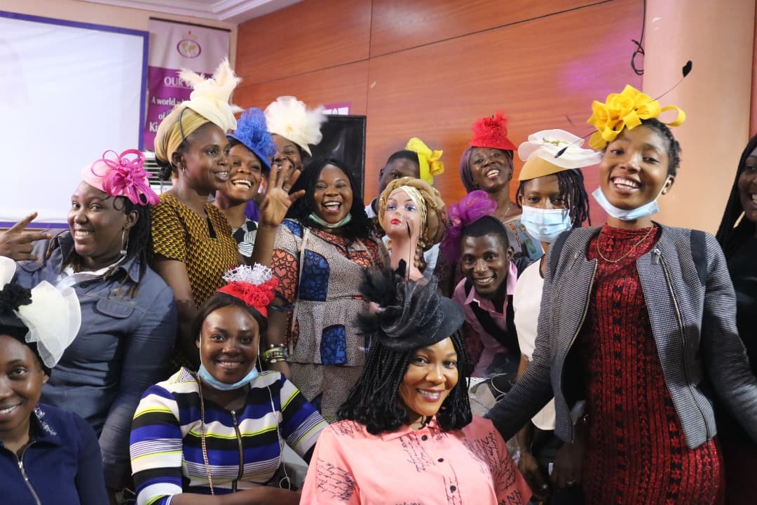 FYCI team and participants in colorful hats and fascinators